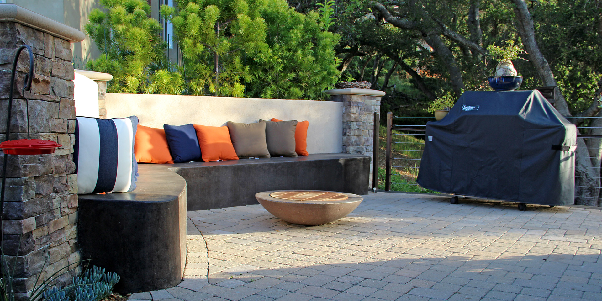 paver patio with concrete walls and pillows
