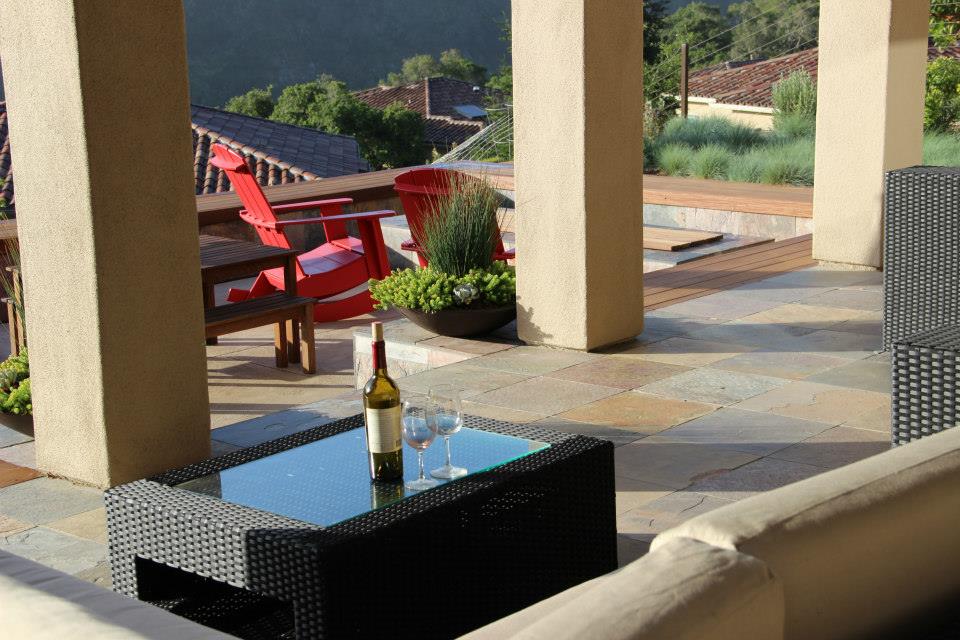 stone patio with columns and glass topped table